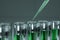 Pipette add liquid to a test tube with green liquid. The concept of vaccine, technology, medicine, research. 3D rendering, 3D