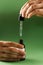 Pipette with Cannabidiol CBD oil in hand. CBD oil from the Cannabis plant to help reduce pain, anxiety, and sleep