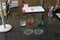 Pipette and colourful chemical liquid solutions in flasks on laboratory worktop