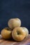 Pippin apples close-up, on wooden table, selective focus, gray background, vertical,