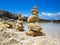 Piramide stack of zen stones near sea and blue sky