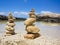 Piramide stack of zen stones near sea and blue sky