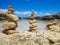 Piramide stack of zen stones near sea and blue sky