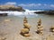 Piramide stack of zen stones near sea and blue sky