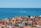 PIRAN, SLOVENIA - 08/15/2020: Panoramic view on roofs and blue sea with yachts