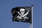 Pirate flag flying in blue sky
