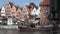 Pirate-like tourist sailing ship moving along waterfront of old medieval city