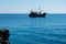 Pirate ship sailing in the sea. View from a cave