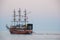 Pirate ship, sailing type, moored at the pontoon pier early in the morning.