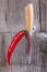 Piri piri chilli pepper stands ajar vertically on a kitchen knife