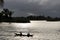 Pirogue under stormy sky