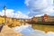 Pisa, Arno river, lamp and buildings reflection. Lungarno view.