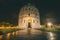 The Pisa Baptistery of St. John close to the leaning tower of pisa at night.