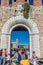 Pisa, Italy - 25 June 2018: The leaning tower of pisa viewed through entrace arch of Piazza dei Miracoli