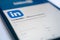 Pisa, Italy - October 23, 2022: Linkedin social network logo on new tablet and smartphone. Installing a program of the social