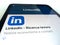 Pisa, Italy - October 23, 2022: Linkedin social network logo on new tablet and smartphone. Installing a program of the social