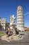 Pisa Leaning tower and Angels sculpture in Italy in summer