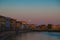 Pisa\\\'s Twilight Serenade: Sunset Waters and Silhouetted Charm