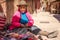 Pisaq, Peru - Old Woman Making and Selling Artifacts at the Pisaq Market