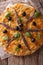 Pissaladiere with anchovies, olives and onion close-up. vertical