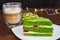 Pistachio cake with kiwi, cream and raspberry filling and Cappuccino coffee