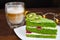 Pistachio cake with kiwi, cream and raspberry filling and Cappuccino coffee