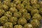 Pistachio rolled vanilla flavored energy balls in close up