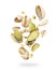 Pistachios crushed into pieces in the air on a white background