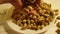 Pistachios health kernel hand pours appetizer table wooden plate background