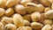 Pistachios. Nuts close - up video in high quality. Slow camera movement, smooth vertical panorama from bottom to top