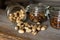 Pistachios scattered on the white vintage table from a jar and with other nuts on background. Pistachio is a healthy