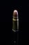 Pistol bullet. Metal case. Old ammunition. Cartridge on a black background. Macro shot of a bullet.