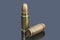 Pistol cartridges of caliber 7.62 mm and 9 mm on gray background