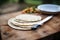 pita bread on a board with a serrated knife