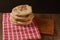 Pita breads or arabian bread stacked on a rustic cloth and a cutting board on a wooden table with black background