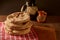 Pita breads or arabian bread stacked on a rustic cloth and a cutting board on a wooden table with black background