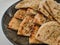 Pita breads served in a black dish