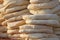 Pita. Pile of roasted pita, baked flat bread. Heap of focaccia. Lavash. Purlenka. Bread background. Flat bread background texture.