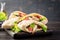 Pita stuffed with chicken, tomato and lettuce on wooden background.