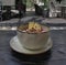 Pitaya breakfast bowl. White rustic black wooden background. Acai superfood smoothie bowl with pineapple slices, banana