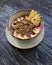Pitaya breakfast bowl. White rustic black wooden background. Acai superfood smoothie bowl with pineapple slices, banana