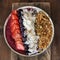 Pitaya breakfast bowl. White rustic wooden background. Acai superfood smoothie bowl with strawberry, blueberry, dragon