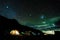 Pitched tents camping at the base of Mount Kilimanjaro at night under the stars