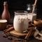 Pitcher of horchata with cinnamon sticks and ice cubes on a wooden table