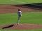 Pitcher lifts leg high as he sets to throw pitch