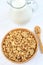 Pitcher with milk and muesli in a bamboo bowl