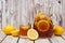 Pitcher of summer iced tea with glass on rustic white wood