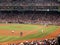 Pitcher throws a pitch as fan do the wave