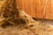 Pitchfork in straw. Pitch Fork stuck into a pile of sunlit straw down on a farm. Concepts of harvesting season, agricultural work