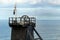 The pithead of a Cornish tin mine showing the main lifting pulley, with a Cornish nationalist Kernow flag